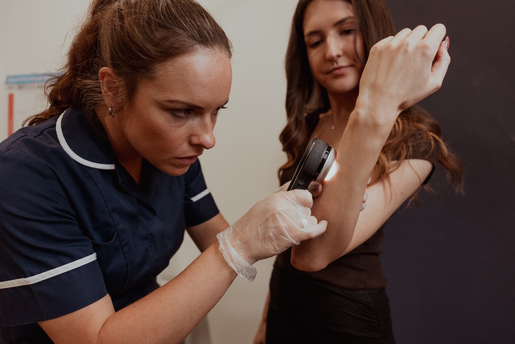 Clinician carrying out a full body skin check